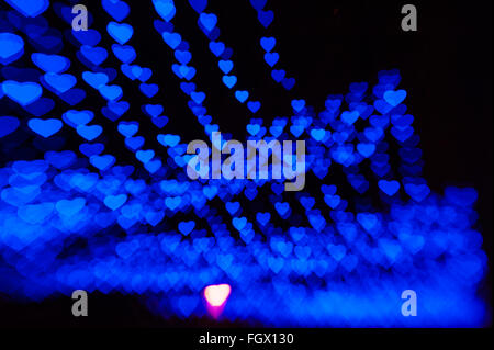 beautiful bokeh made of warm blue blurred lights in the form of hearts Stock Photo