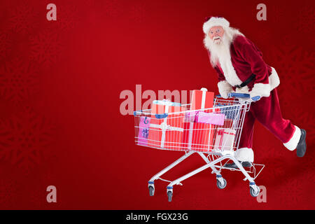 Composite image of santa rides on a shopping cart Stock Photo
