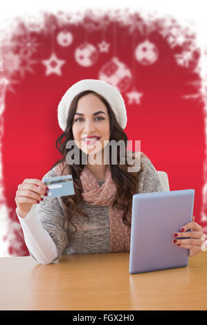 Composite image of woman with tablet and credit card Stock Photo