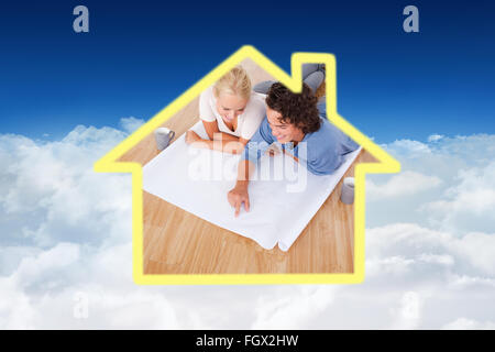 Composite image of young man showing a point on a plan to his fiance Stock Photo