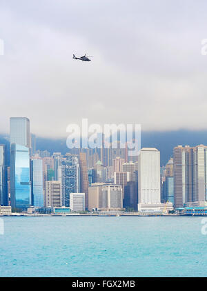 Flying helicopter above the Hong Kong downtown Stock Photo