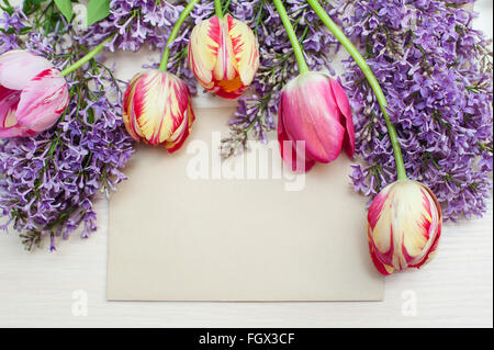 frame from tulips and lilac and place for text greeting card Stock Photo