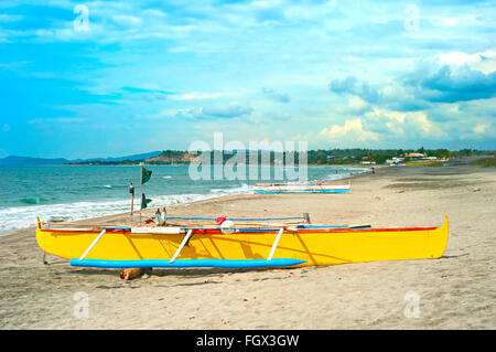 Philippines fisherman boat on a beach and village on a background Stock Photo