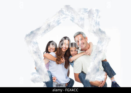 Composite image of smiling parents holding their children on backs Stock Photo