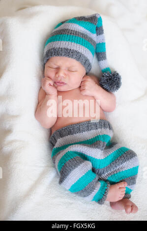 newborn baby sleeps in a knit suit Stock Photo