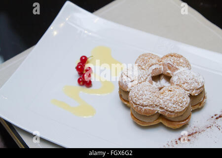 Paris–Brest cake, French dessert, made of choux pastry and a praline flavoured cream. Stock Photo