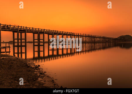Sunset over the historic wooden U Bein Bridge near Mandalay in Myanmar. Long exposure.