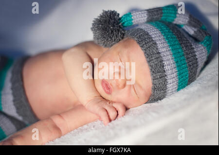 newborn boy sleeps in a knitted cap Stock Photo