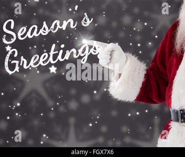 Composite image of santa claus points at something Stock Photo