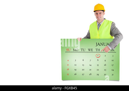 Composite image of smiling builder pointing at something Stock Photo