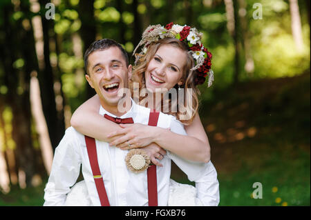 Bride and groom at wedding Day walking Outdoors on spring park Stock Photo