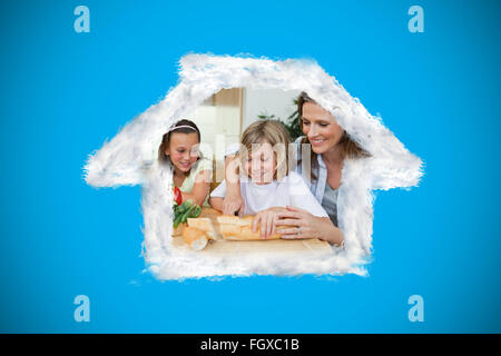 Composite image of woman making sandwiches with her children Stock Photo