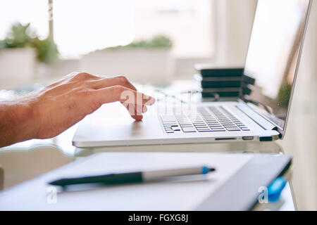 Hand busy operating the touchpad on a notebook Stock Photo