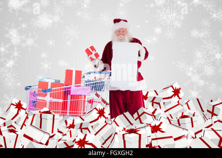 Composite image of santa delivering gifts from cart Stock Photo