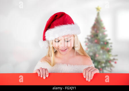 Composite image of festive cute blonde holding poster Stock Photo