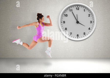 Composite image of fit brunette running Stock Photo