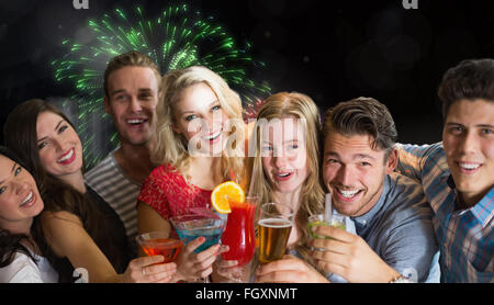 Composite image of friends drinking cocktails Stock Photo