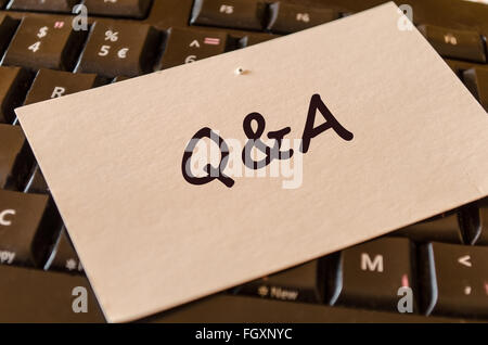 Computer Keyboard with white note and text Q&a Stock Photo