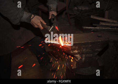 Blacksmith forfing hot iron Stock Photo