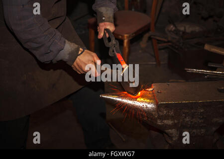 Blacksmith forfing hot iron Stock Photo