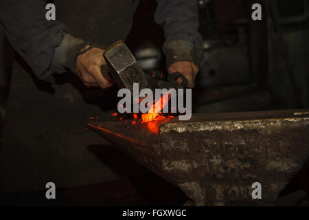 Blacksmith forfing hot iron Stock Photo