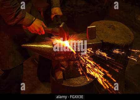 Blacksmith forfing hot iron Stock Photo