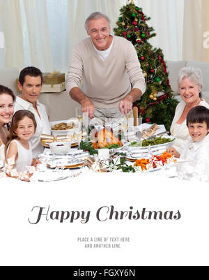 Composite image of grandfather cutting turkey for christmas dinner Stock Photo