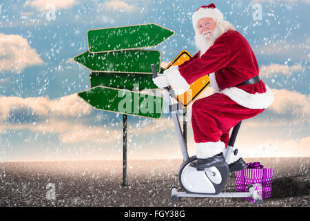 Composite image of santa uses a home trainer Stock Photo