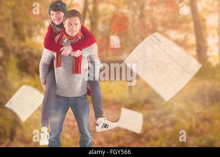Composite image of man giving girlfriend piggy back Stock Photo