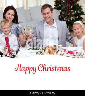 Composite image of parents toasting with wine in christmas dinner Stock Photo