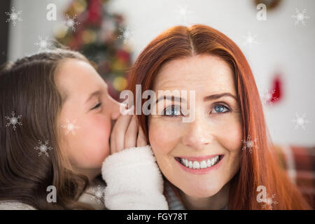 Composite image of daughter telling her mother a christmas secret Stock Photo