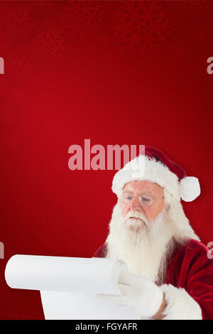Composite image of santa checking his list Stock Photo - Alamy