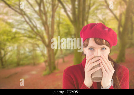 Composite image of woman drinking from a cup Stock Photo