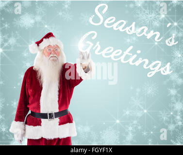 Composite image of santa claus points at something Stock Photo