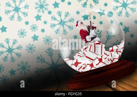 Santa rocking out in snow globe Stock Photo