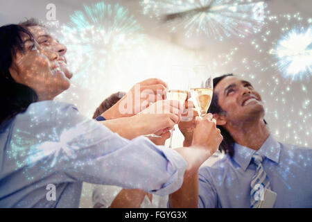 Composite image of cheerful business team toasting with champagne Stock Photo