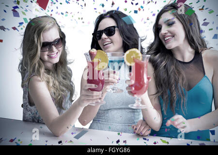 Composite image of friends drinking cocktails Stock Photo