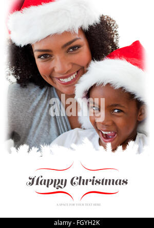 Composite image of mother and daughter having fun at christmas time Stock Photo