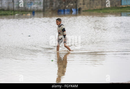 Gaza. 22nd Feb, 2016. A Palestinian boy walks in the flooded water during a winter storm in the village of Al-Moghraga near the Nuseirat refugee camp in the central Gaza Strip, on Feb. 22, 2016. Credit:  Wissam Nassar/Xinhua/Alamy Live News Stock Photo