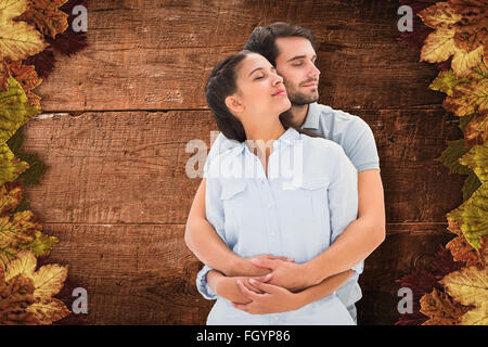 Composite image of cute couple embracing with eyes closed Stock Photo
