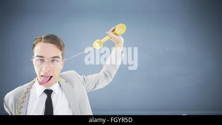 Composite image of geeky businessman being strangled by phone cord Stock Photo