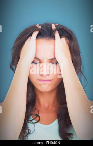 Composite image of pretty brunette with a headache Stock Photo