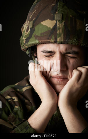 Soldier In Uniform Suffering From Stress Stock Photo