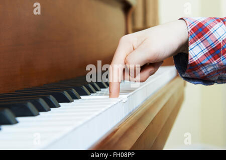 Close Up Of Child's Hands Playing Piano Stock Photo