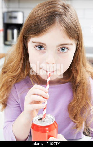 Young Girl Drinking Can Of Soda Through Straw Stock Photo