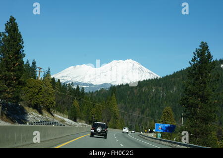 Road leading to Mount Shasta, California, USA, beautiful tall snow covered mountain, a famous tourist destination, volcanic Stock Photo