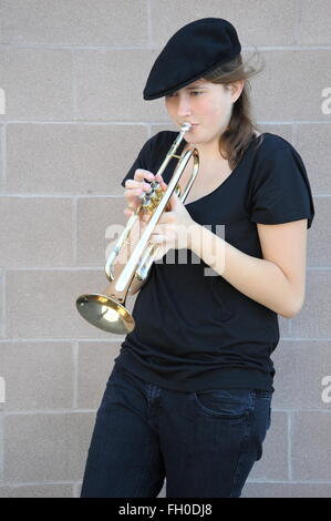 Female trumpet player blowing. Stock Photo