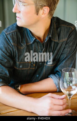 A young man enjoys a glass of wine in Santa Ynez, California. Stock Photo