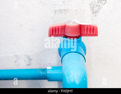 Red plastic valve for control the water to tank, select focus. Stock Photo