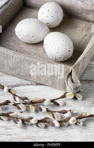 Bright,carved Easter eggs on a background of willow branches Stock Photo